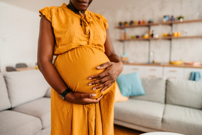 Pregnant woman holding her belly